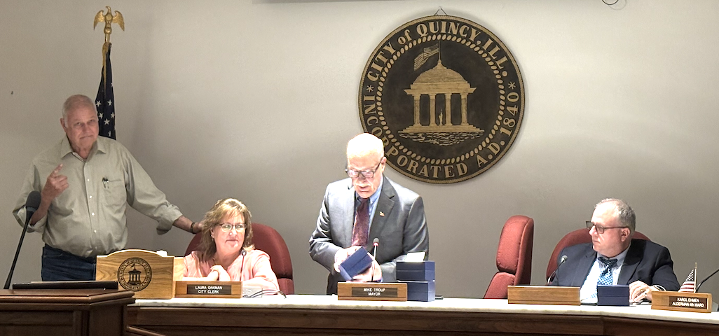 Mayor Mike Troup receives a commemoratory gemstone for his service to the city